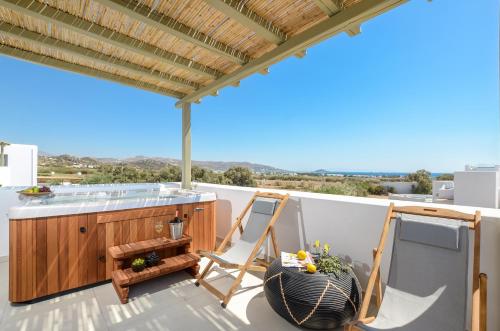 a balcony with a table and chairs on a roof at Sea & Olives Suites Hotel and Villas in Plaka