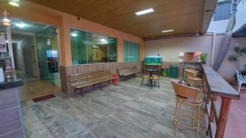 a room with benches and a bar in a building at Hotel Pousada Aeroporto in Goiânia