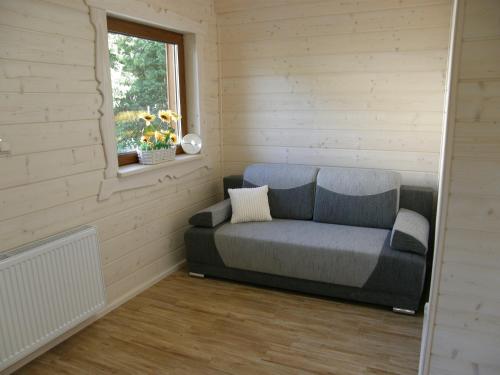 a couch in a corner of a room with a window at Willa u Bartusia in Wisła