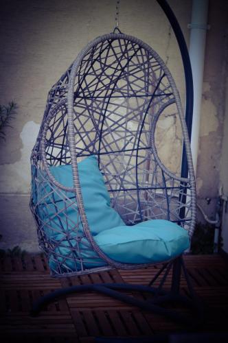 a swing chair with a blue cushion in a room at Loft 47 Spa in Chambly