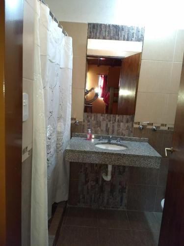a bathroom with a sink and a mirror at Cabañas Peumayen in Colón