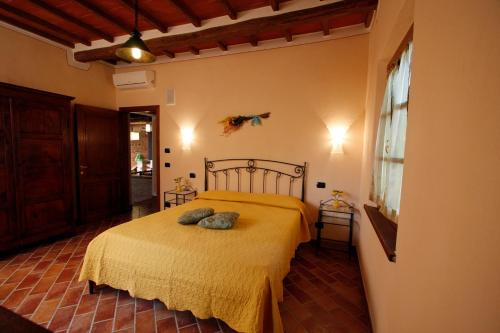 a bedroom with a bed with two pillows on it at Villa Farnetina in Cortona
