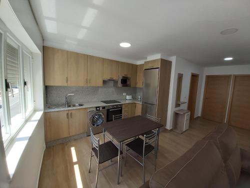 eine Küche mit einem Tisch und Stühlen im Zimmer in der Unterkunft Apartamento Adriana in O Pindo