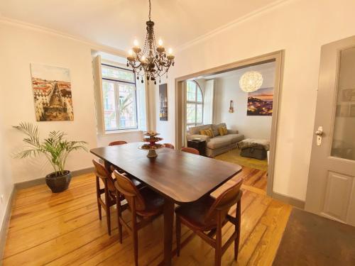 a dining room with a table and chairs at Luxury Vintage apartment by MyPlaceForYou, at the city centre next to Marquês de Pombal in Lisbon