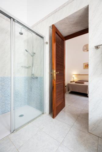 a bathroom with a shower and a glass door at Finca el Moral in Puerto de Mogán