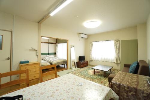 a room with a bedroom with a bed and a mirror at Mark's HOME in Maebashi