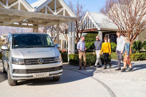 a group of people standing next to a van at Millbrook Resort in Arrowtown