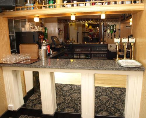 a bar with a counter top in a room at Clifton Park Hotel - Exclusive to Adults in Lytham St Annes
