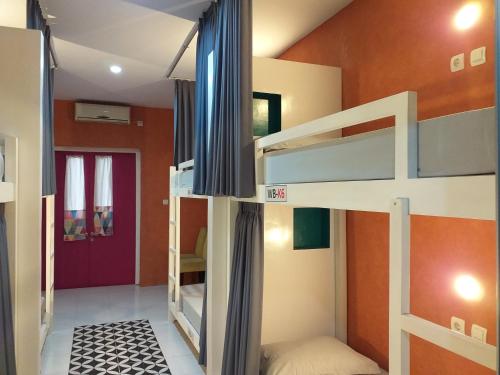 a bedroom with two bunk beds in a room at Home Addicts Hostel in Yogyakarta