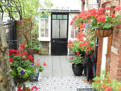 an entrance to a house with flowers in pots at The Rutlands B&B in Windsor