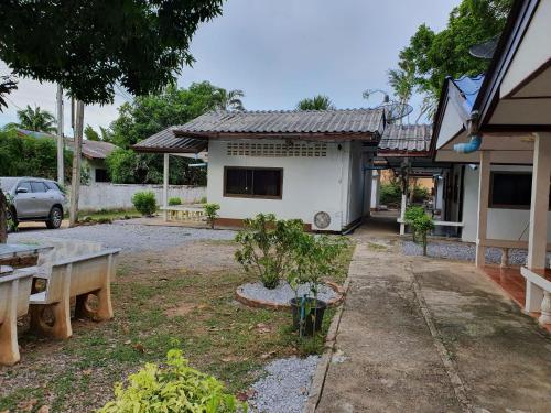 a house with a picnic table in front of it at pineapple resort in Ban Huai Thalaeng Phan