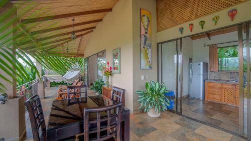 a kitchen and dining room with a table and chairs at La Finca Lodge in Fortuna