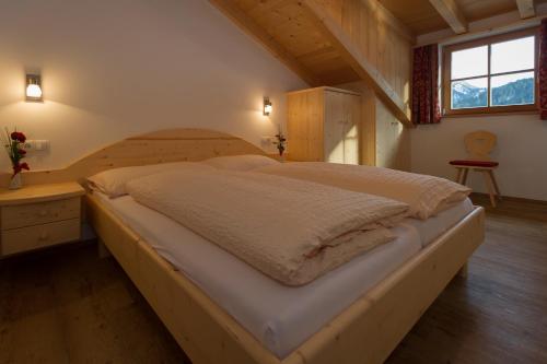 a bedroom with a large bed in a attic at Appartments Jagerhof in Braies