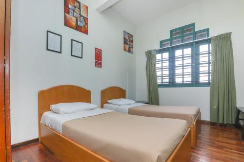 2 camas en una habitación con ventana en SPOT ON 89789 Hotel Check In 2 en Brinchang