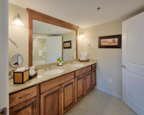 a bathroom with two sinks and a large mirror at The Residences at Biltmore - Asheville in Asheville