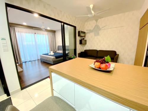 a kitchen with a bowl of fruit on a counter at Almas Suites Puteri Harbour in Nusajaya