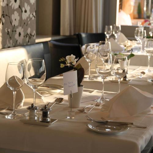 a table with wine glasses and napkins on it at Guggital Hotel Restaurant in Zug