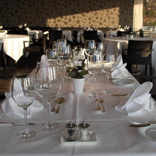 a table with wine glasses and napkins on it at Guggital Hotel Restaurant in Zug
