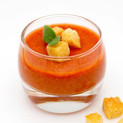 a glass jar of tomato sauce with a garnishment at Guggital Hotel Restaurant in Zug