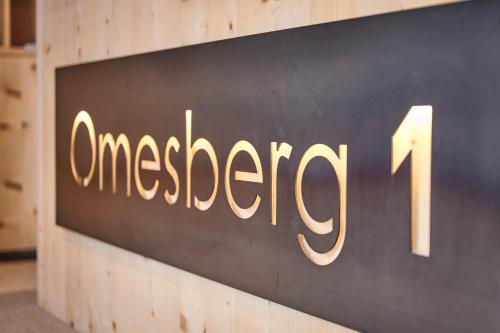 a sign on a wall that reads amega at Appartement Omesberg 1 in Lech am Arlberg