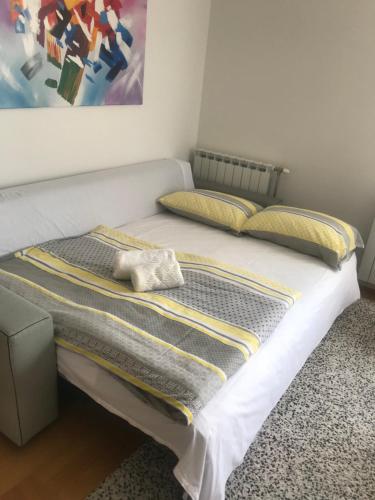 a bed in a room with a painting on the wall at Luna Apartments, apartments with style in Zagreb