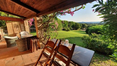 a table and chairs on a patio with a view at I Mirti B&B in San Pantaleo