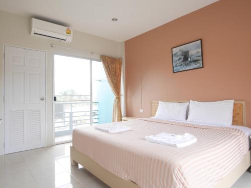 ein Schlafzimmer mit einem Bett mit zwei Handtüchern darauf in der Unterkunft Forest Bungalows & Mama's Restaurant in Chalong 