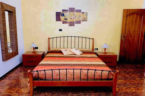 a bedroom with a large bed with two night stands at Flowery House in Miglianico