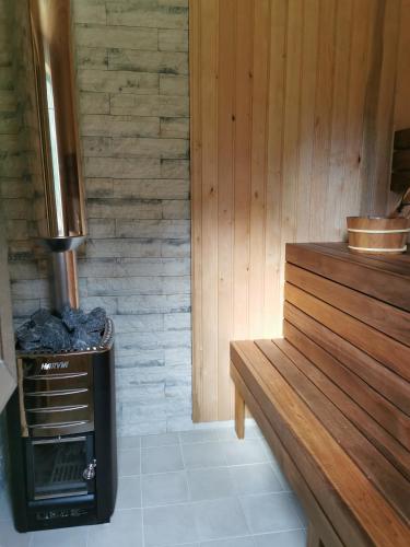 a kitchen with a woodburning stove in a room at Sunset puhkemaja in Kaigutsi