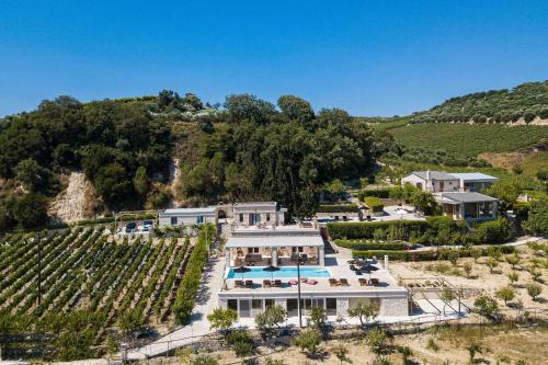 an aerial view of a estate with a vineyard at Villa Mantilari Wine Estate 7 Apartments 2 Private Pools 1 Heated Tennis Court Fitness Center in Archanes