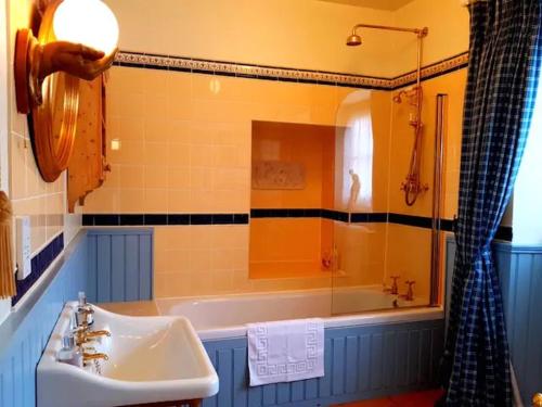 a bathroom with a sink and a bath tub at No 6 The Square Tearooms & Accommodation in Buxton
