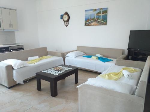 a living room with two couches and a coffee table at Grand Seaview Apartments in Ksamil