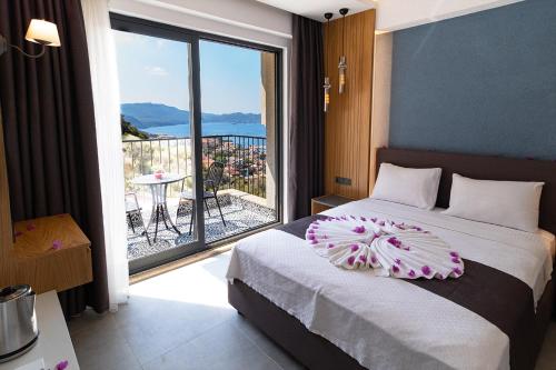 a bedroom with a bed with a view of a balcony at Granda Apart in Kaş