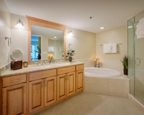a bathroom with a tub and a sink and a shower at The Residences at Biltmore - Asheville in Asheville