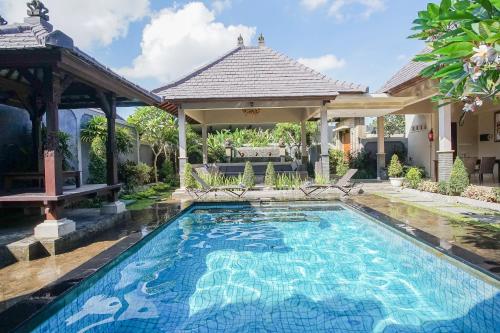 a swimming pool in the backyard of a house at Dura Villas Bali at Kerobokan in Kerobokan