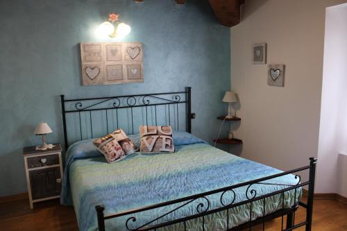 a bedroom with a bed with pillows on it at Agriturismo La Fine in Piancaldoli