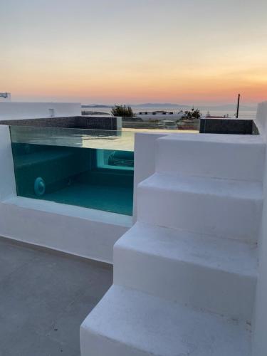 a glass table on top of a white building at Eternal Suites in Mýkonos City
