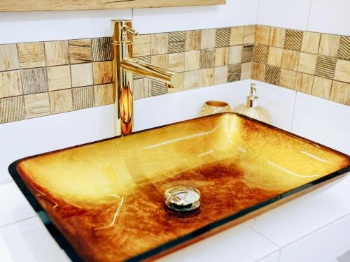 a copper sink in a bathroom with a tap at Kaszubskie Zacisze in Władysławowo