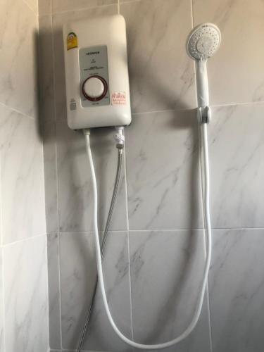 a soap dispenser on a wall in a bathroom at Chai Style Mansion in Ban Khlong Bang Bon