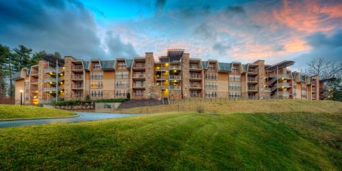 a large apartment building with a rainbow in the sky at The Residences at Biltmore - Asheville in Asheville