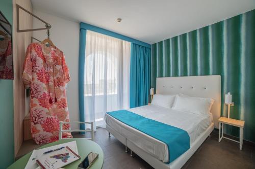 a bedroom with a bed and a large window at Il Piccolo Giardino GH ***Superior in Taormina