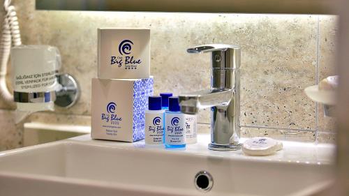 a bathroom sink with hygiene products on it at Club Big Blue Suit Hotel - All Inclusive Plus in Alanya