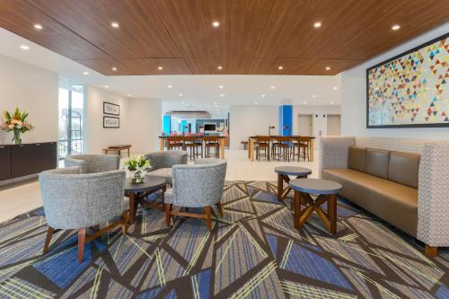 a lobby with a couch and chairs and a table at Holiday Inn Express & Suites Fort Worth Downtown by IHG in Fort Worth