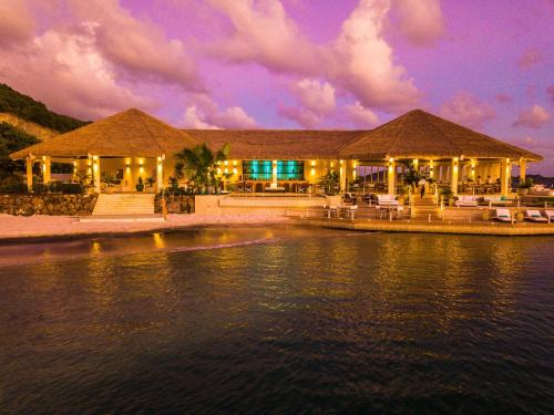 a resort on the water at night at The Liming Bequia in Friendship