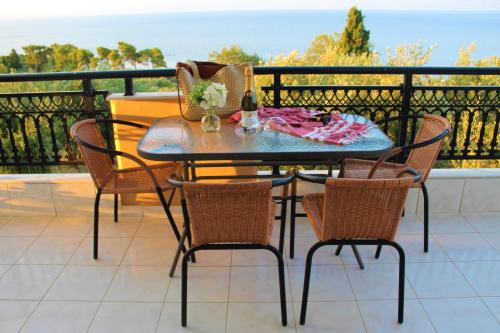 a table and chairs on a balcony with a view at Sofia Apartments in Koroni
