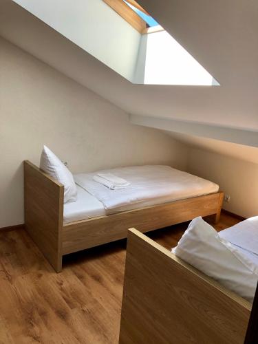 two beds in a small room with a skylight at Summer spot Nida in Nida