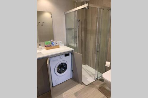 a bathroom with a washing machine and a shower at céntrico apartamento La Llum 1A in Alicante