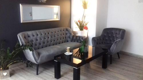 a waiting room with two chairs and a table at Karat in Warsaw