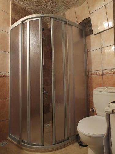 a shower stall in a bathroom with a toilet at Anatolia cave hotel Pension in Goreme
