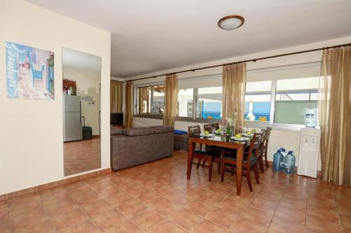 a living room with a table and a couch at Seafront Protaras Apartments in Protaras
